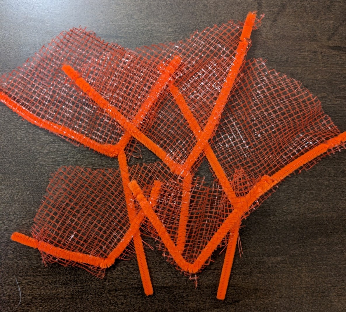 Orange pipe cleaners made into fan corals.