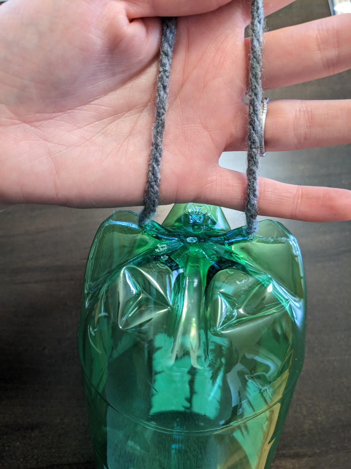 The bottom of the bottle, with a string through for hanging.