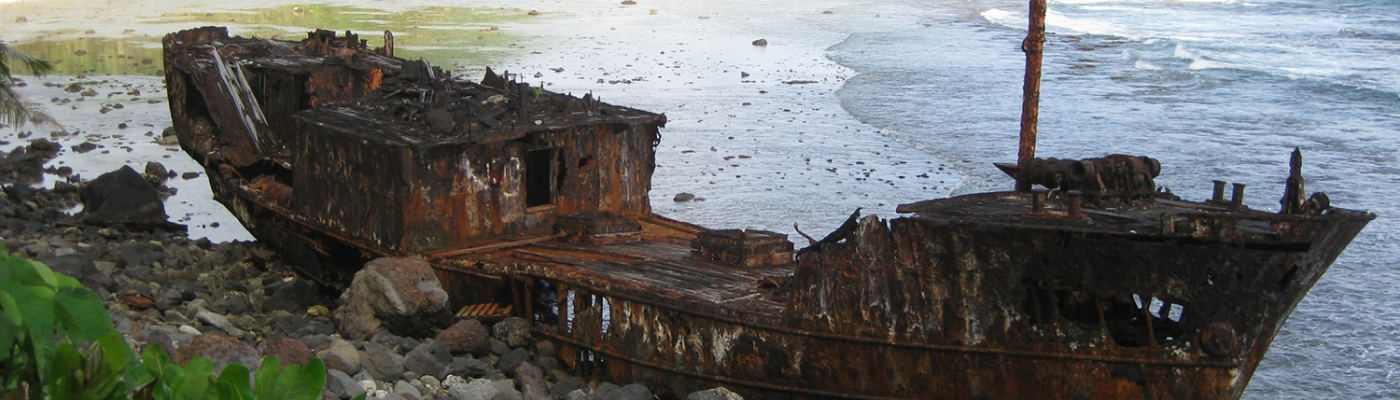 Rusted ship on the beach.