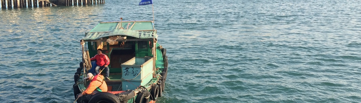 People remove marine debris floating in Hong Kong with nets.