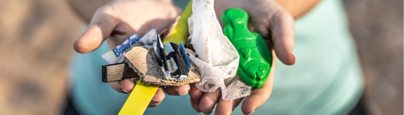 Marine debris held out in cupped hands.