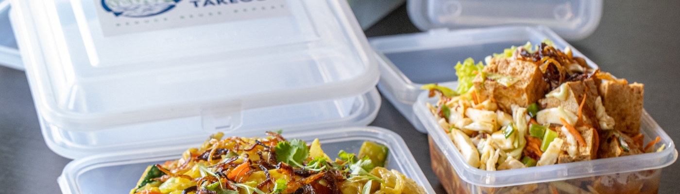 Reusable takeout containers on a counter.