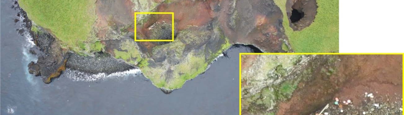 An overhead view of marine debris along a coastline.