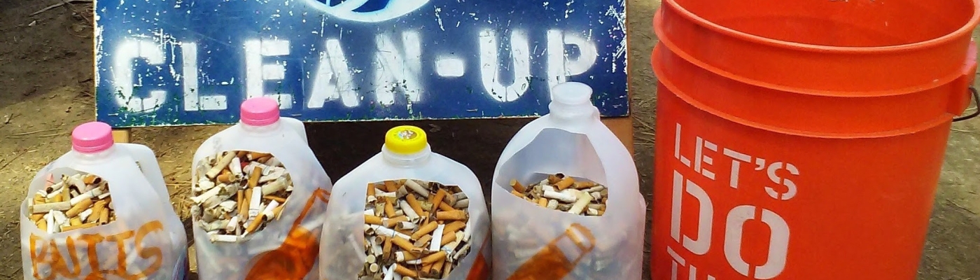 Milk jugs holding collected cigarette butts.