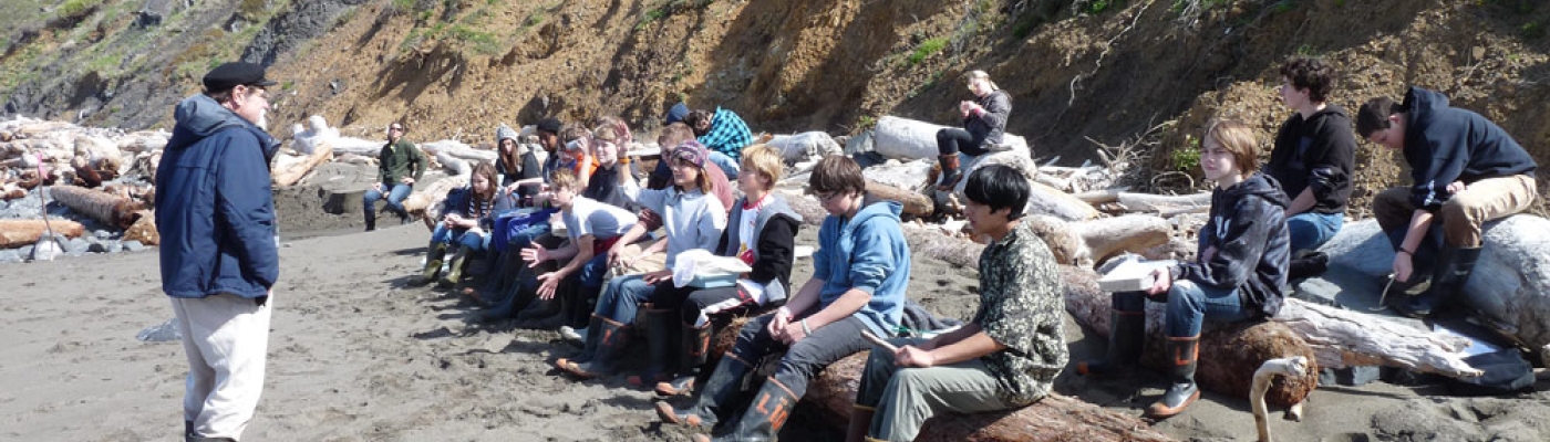 Monitors receive instruction on the beach.