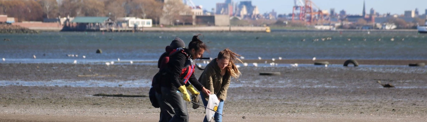 Kids picking up debris on a NYC beach.