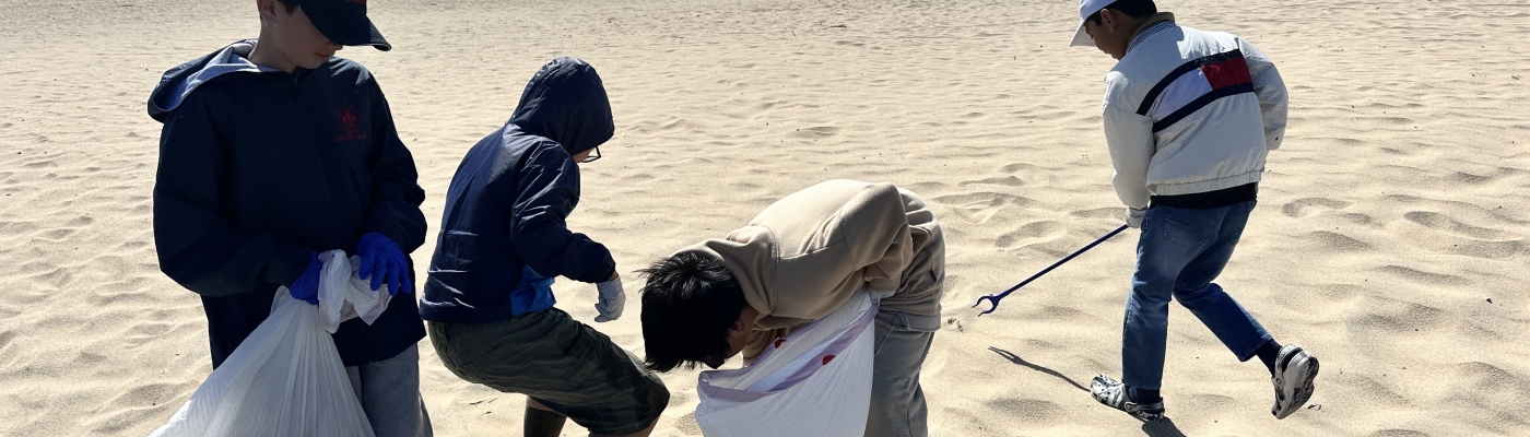 Boys participating in a beach cleanup.