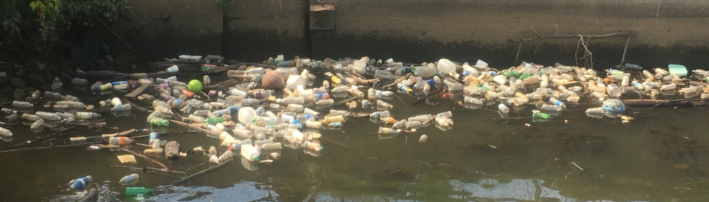 Plastic bottles floating in a river.