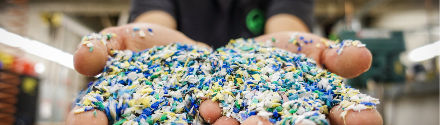 Small fragments of plastic in two outstretched hands.