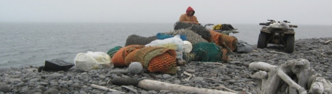 A person hauling collected debris on an ATV.
