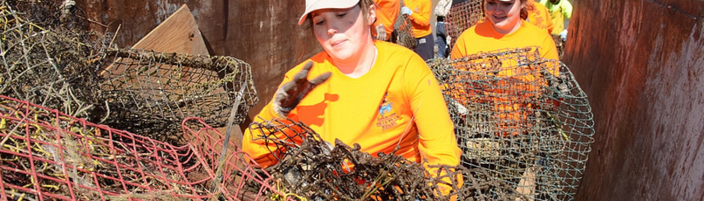 Volunteers fill a container with derelict crab traps collected during a "Derelict Crab Trap Rodeo" in 2014. (Photo Credit: Louisiana Sea Grant)