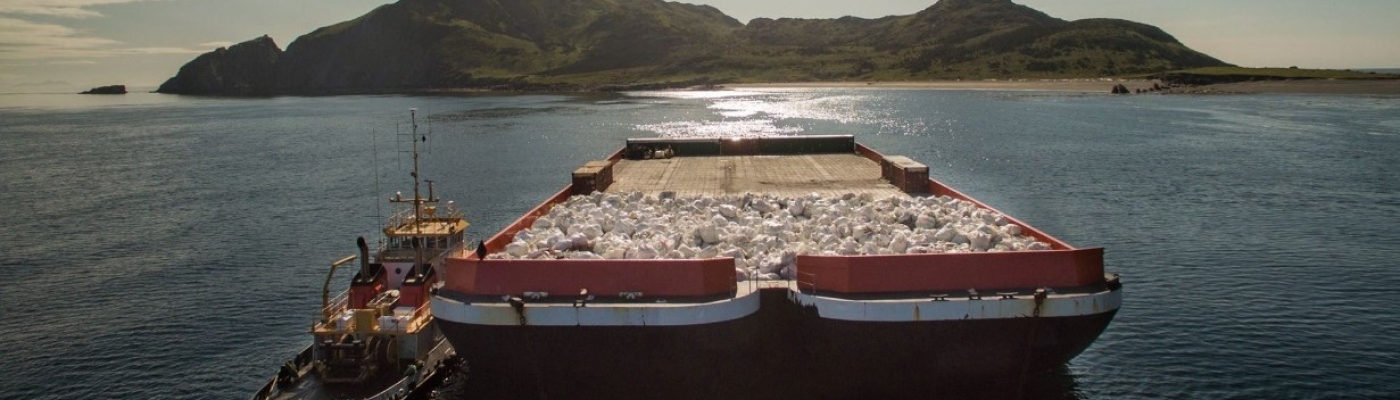 A barge carrying bags of marine debris.