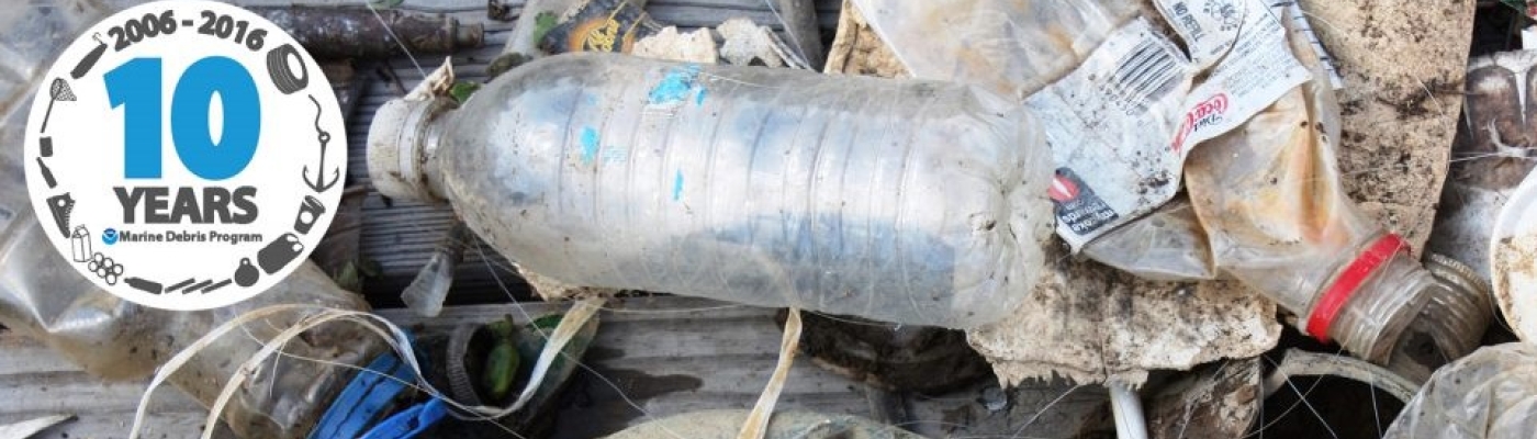 Image of marine debris items with the Marine Debris Program ten year anniversary identity marker.