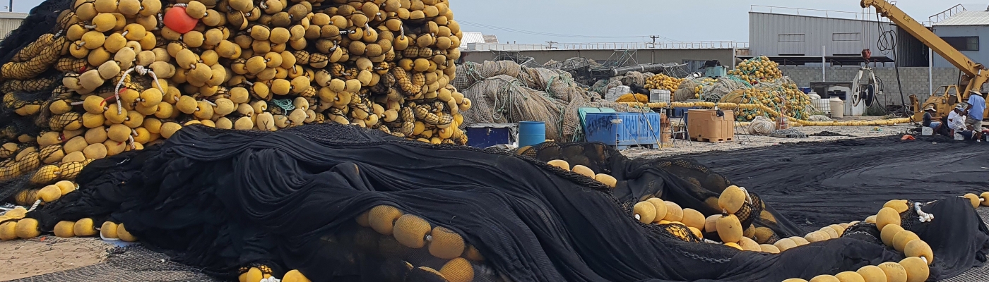 Used fishing gear collected in large outdoor piles.