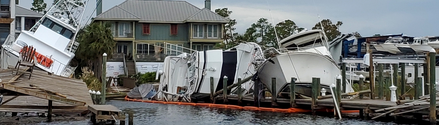 Vessels and a dock left damaged after a hurricane.