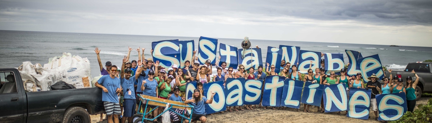 Volunteer clean the beach in Hawaii. 