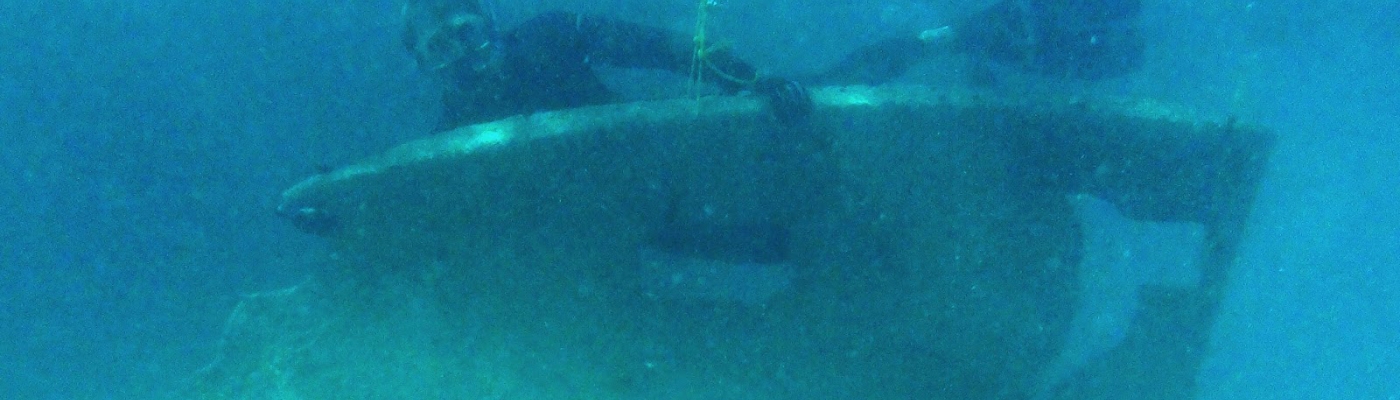 A diver holds a slab of metal removed. 