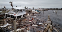 Marine debris piled high along a shore.