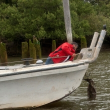 A volunteer removes marine debris from the Quinault reservation in Washington. 