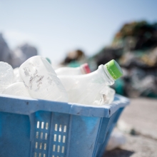 A laundry basket filled with plastic bottles.