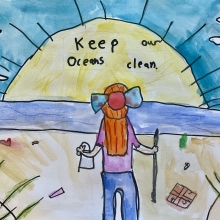 A peaceful beach scene featuring a person with long red hair looking over the ocean while picking up debris, artwork by Hazel P. (Grade 3, Florida), winner of the NOAA Marine Debris Program Art Contest.