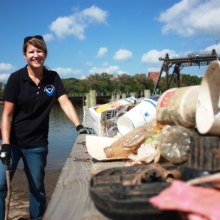 A volunteer stands with some of the haul from the 2015 International Coastal Cleanup.