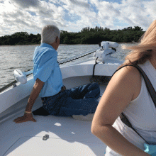 Man sitting on the bow of a boat. 