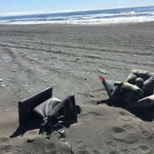 Two armchairs on a beach.