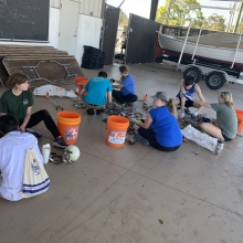 Eckerd College students sorting through debris collected during a beach clean-up.