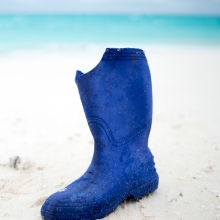 A rubber boot washed up on the sandy shores of North Beach, Sand Island, Midway Atoll.