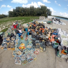 People sitting on a large pile of debris.