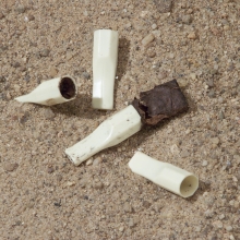 Plastic cigar tips found on a beach.