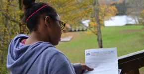 A student looking at her Climate Action Plan at a youth summit. 
