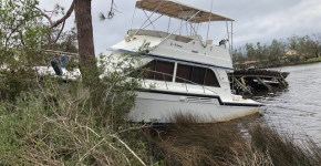 A derelict vessel grounded on the shore.