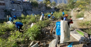 A group of people cleanup a creek.