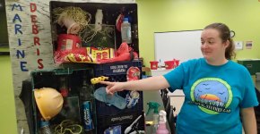 A graduate student with UTRGV's Coastal Studies Lab presents a marine debris display.