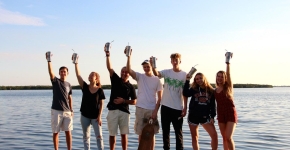 A group of students on a beach. 