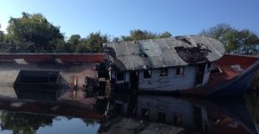 An Abandoned and Derelict Vessel in a Waterway.