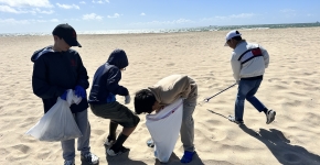 Boys participating in a beach cleanup.