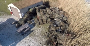 A pile or derelict crab traps next to a shed.