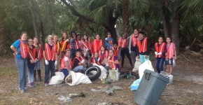 A group of students with trash they collected.
