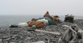 A person hauling collected debris on an ATV.