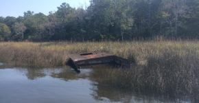 Derelict vessel stuck in marsh. 