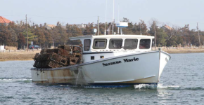 A boat hauling collected derelict/abandoned gear back to shore.