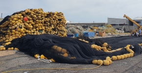 Used fishing gear collected in large outdoor piles.