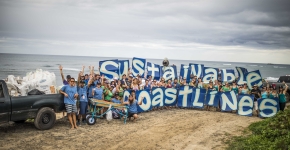 Volunteer clean the beach in Hawaii. 