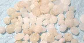 Plastic nurdles spread out on a table