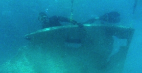 A diver holds a slab of metal removed. 