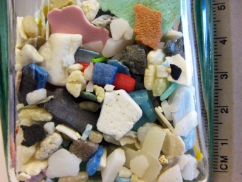 Colorful microplastics in a bottle.