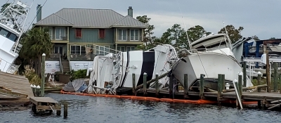 Vessels and a dock left damaged after a hurricane.